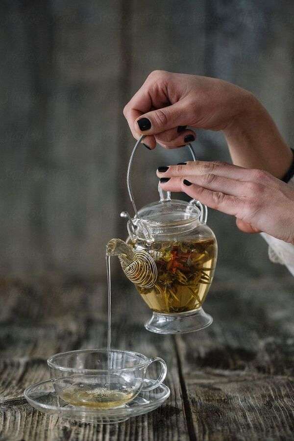Warm tea poured into a simple cup on a calm table setting
